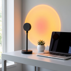 Sunset projection lamp glowing on a modern desk beside a laptop