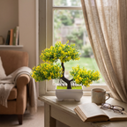 Faux blossom bonsai tree on a sunlit windowsill in a living room