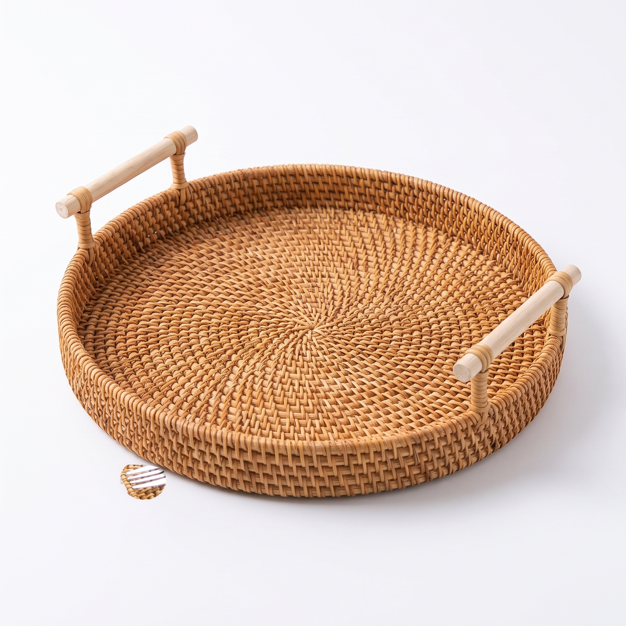 Handwoven rattan tray basket on a pure white studio background