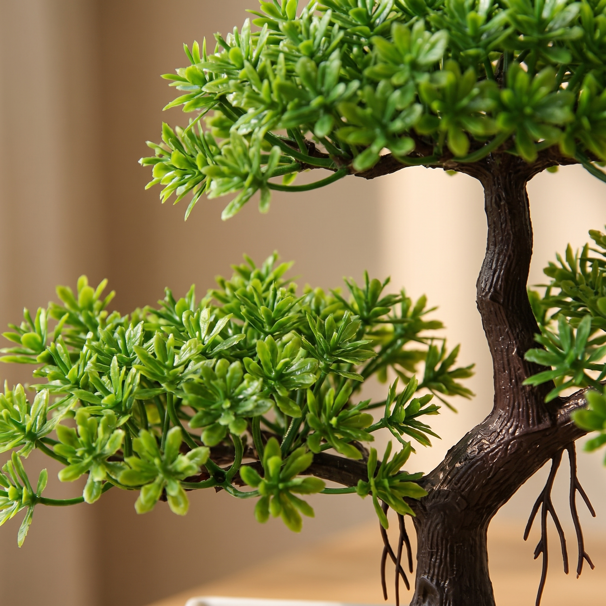Close detail of the layered foliage on the faux bonsai tree